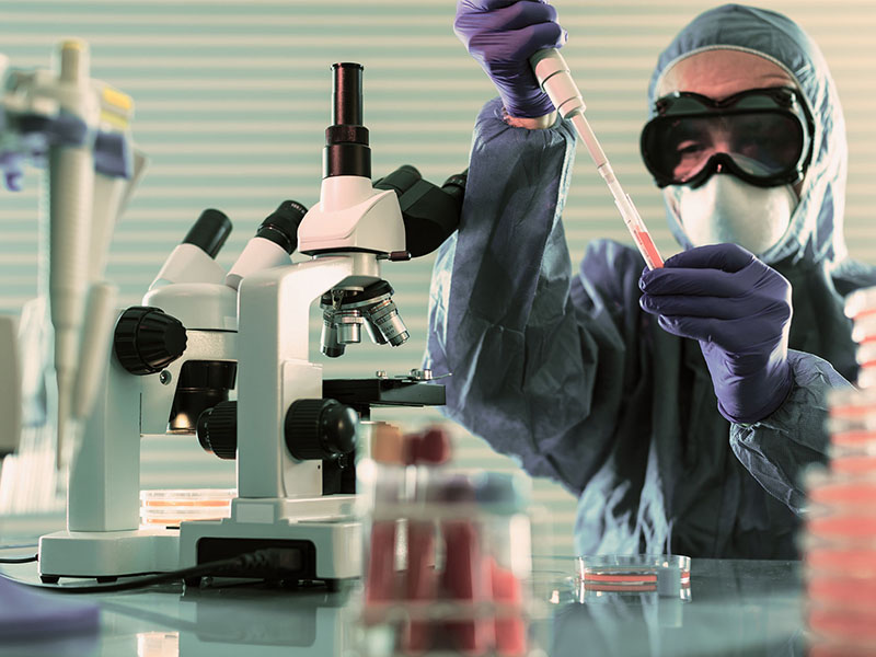 Person in lab coat testing blood