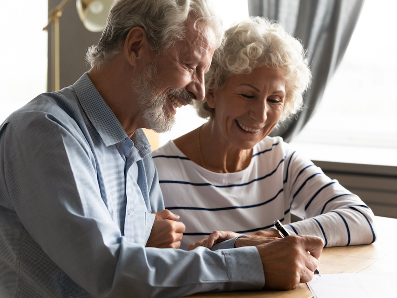 Satisfied senior couple signing agreement buying medical health insurance alternate text for this image