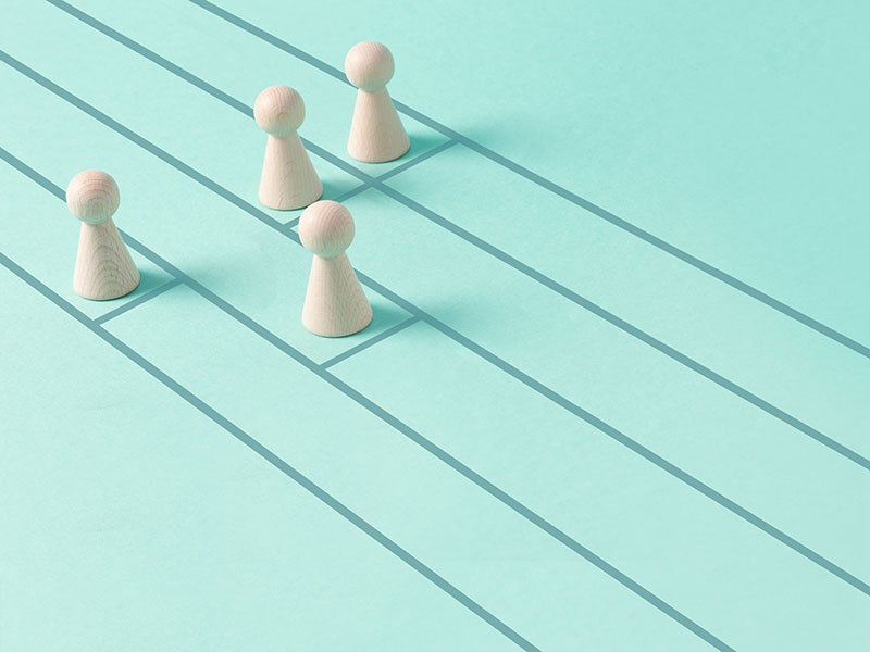 chess pieces at starting line with headstart for one piece