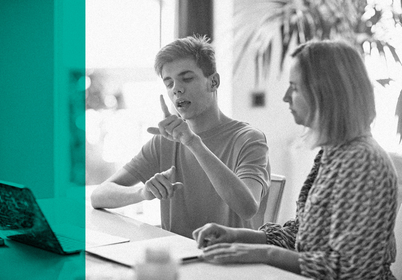 Young man using sign language with an older woman