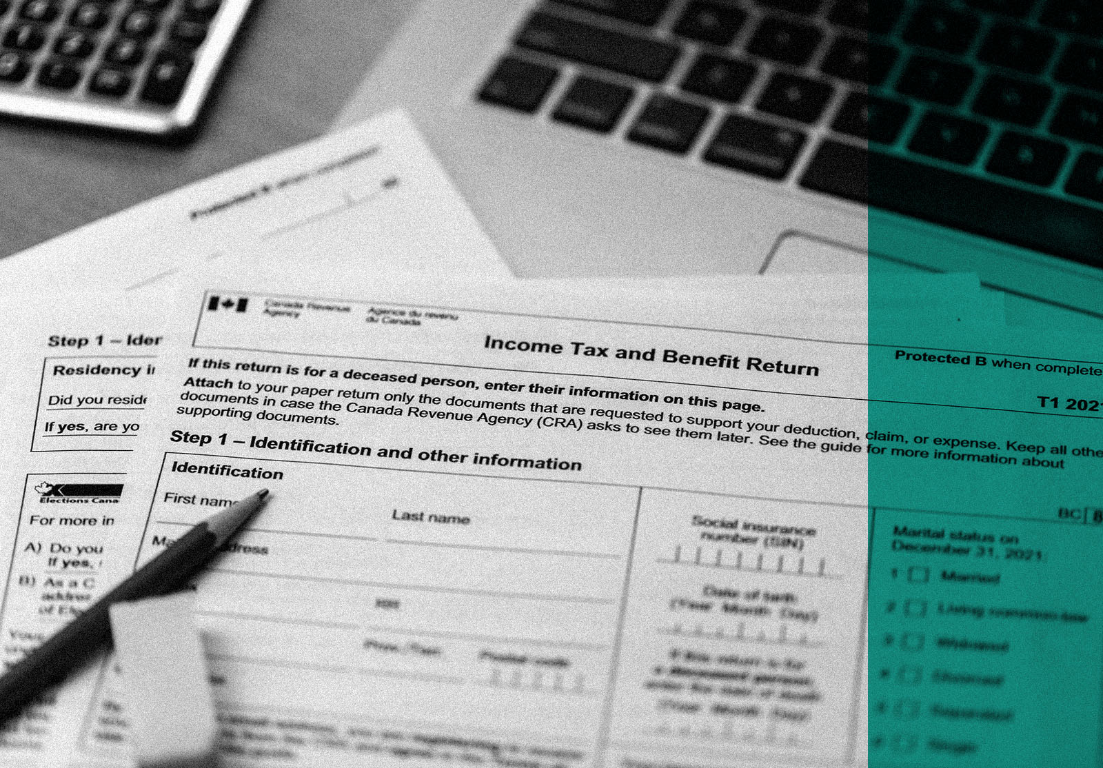 The canadian income tax and benefit return form with calculator, laptop and pen surrounding it