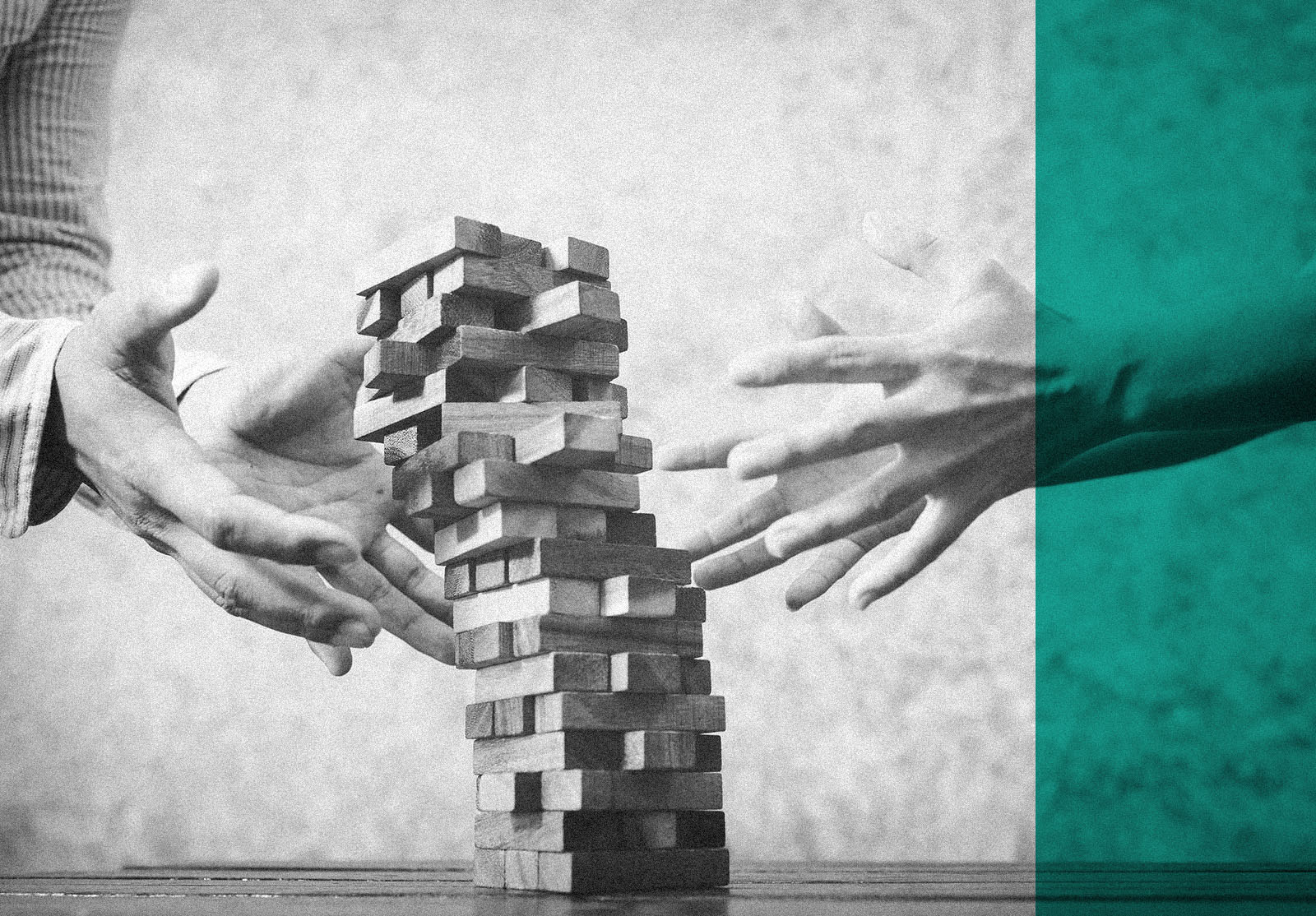 Man and woman playing wood jenga game, tower collapses