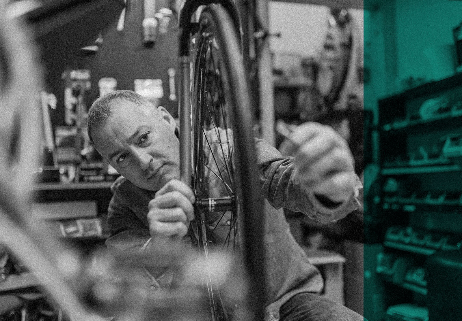 Friendly and competent bicycle mechanic in a workshop repairs a bike