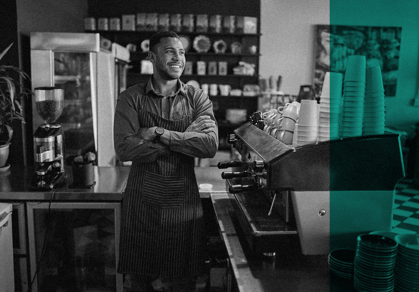 Thoughtful small coffee shop owner standing behind counter