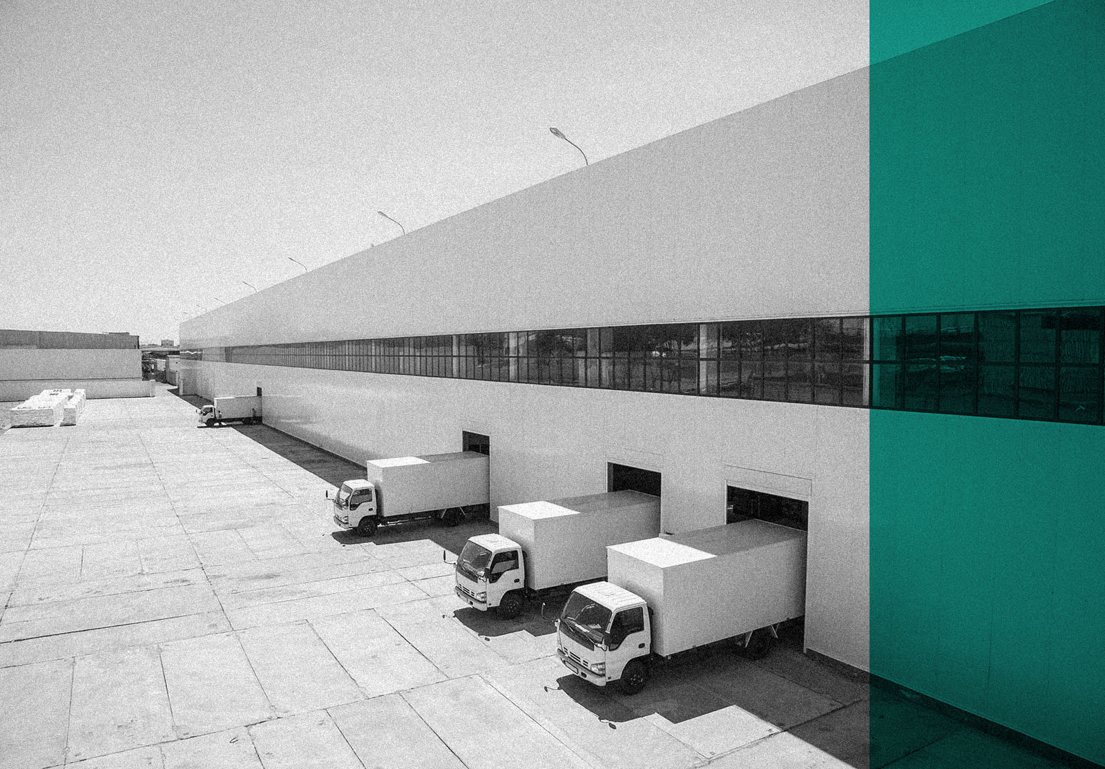 facade of an industrial building and warehouse with freight cars in length