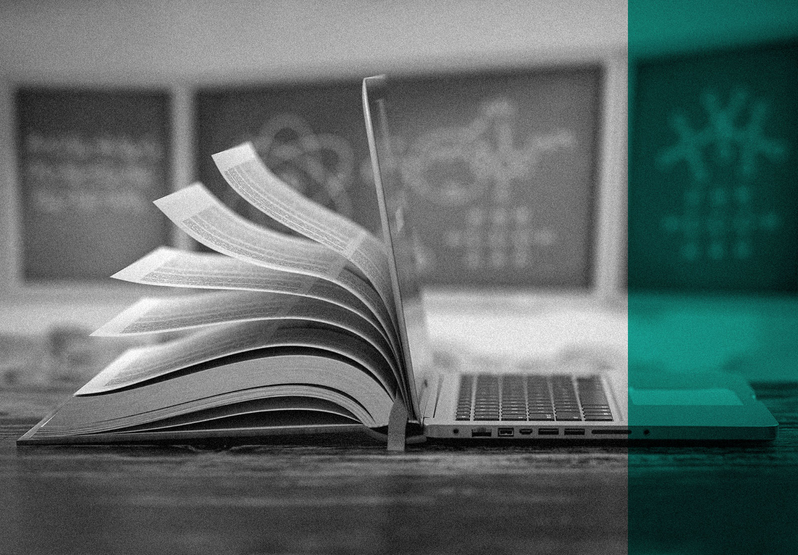 Book and laptop in front of classroom