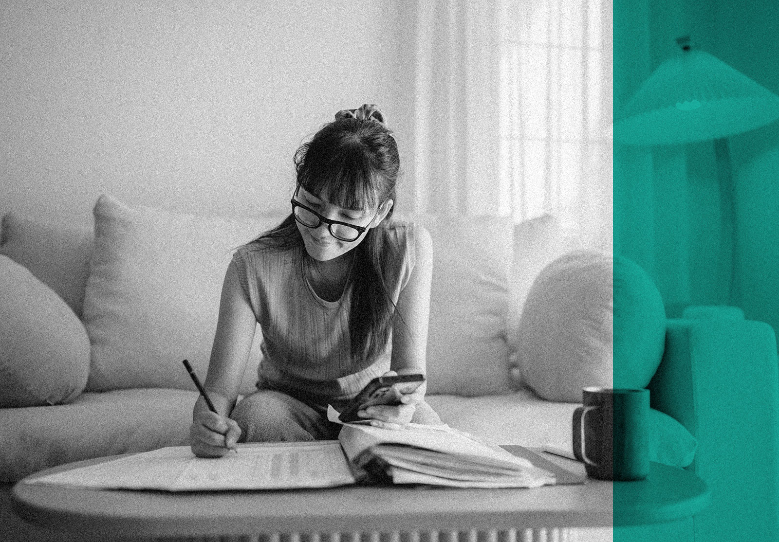 Young woman looking at financial records in her living room at home