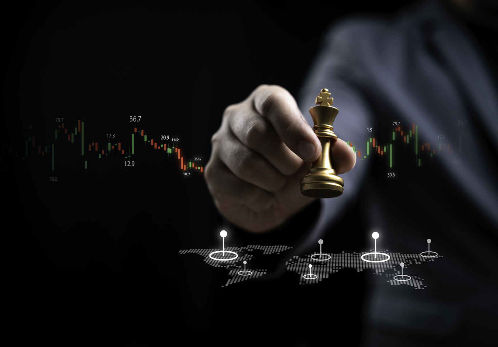 Businessman holds a golden chess piece against a backdrop of stock market graphs and a digital world map, symbolizing strategic decision-making in finance and trading strategies concept. alternate text for this image