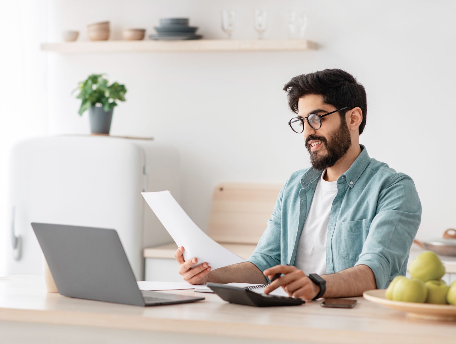 Young Canadian investing on laptop