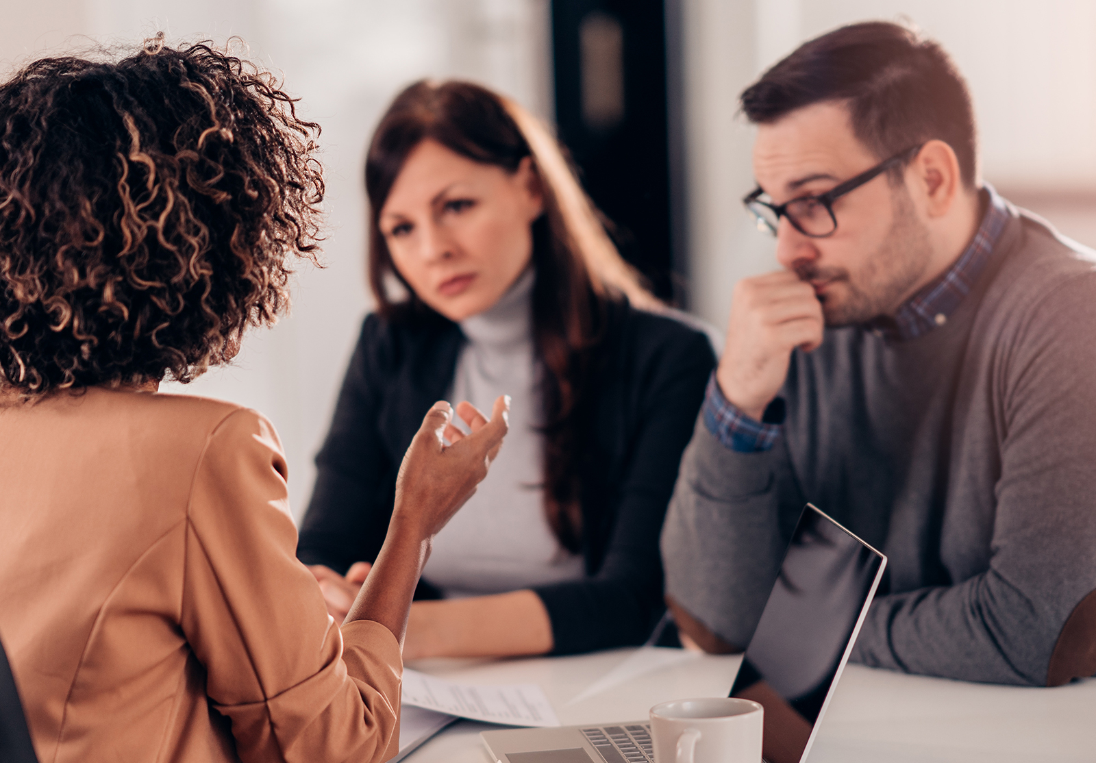 Couple consulting with a female financial manager at the bank