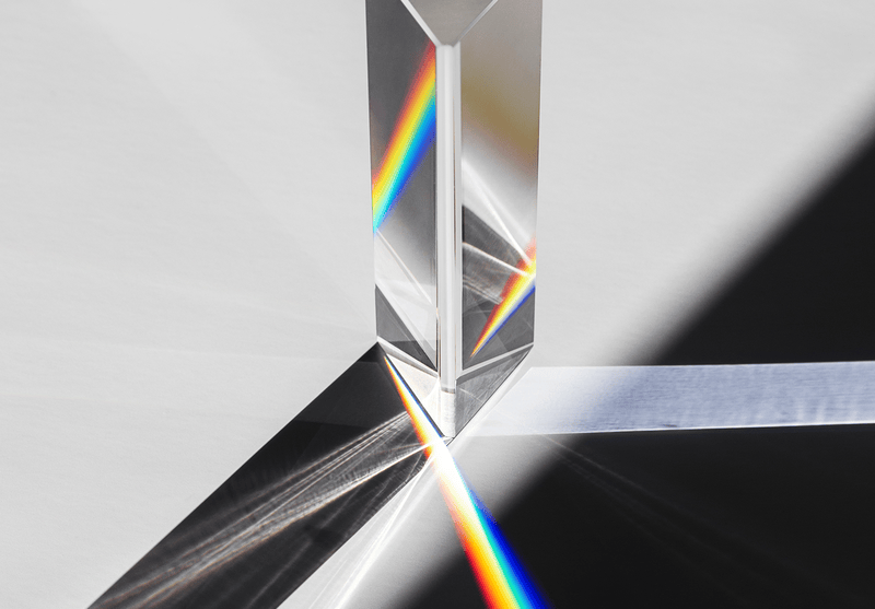Light passing through a prism creating a rainbow spectrum.