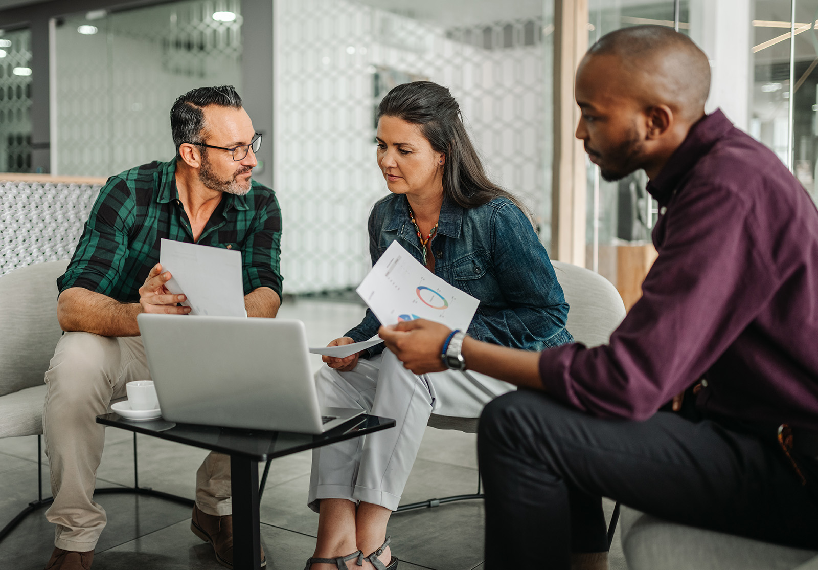 Casual meeting of diverse business team analyzing financial data